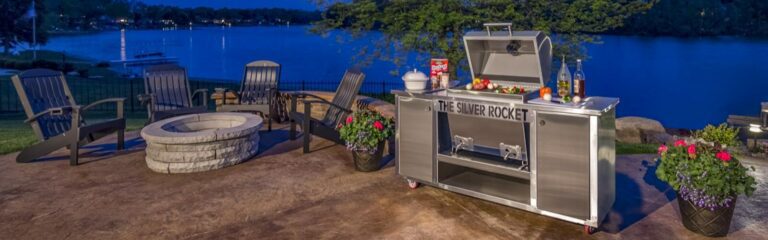 Silver Rocket Grill on a patio beside a lake