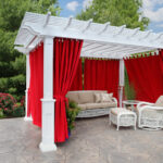 Red curtains on a white pergola
