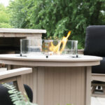 Donoma 44 Inch Fire Pit in Weatherwood with a 20-R Round Glass Wind Guard
